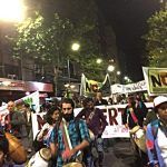 Protestors play drums and march